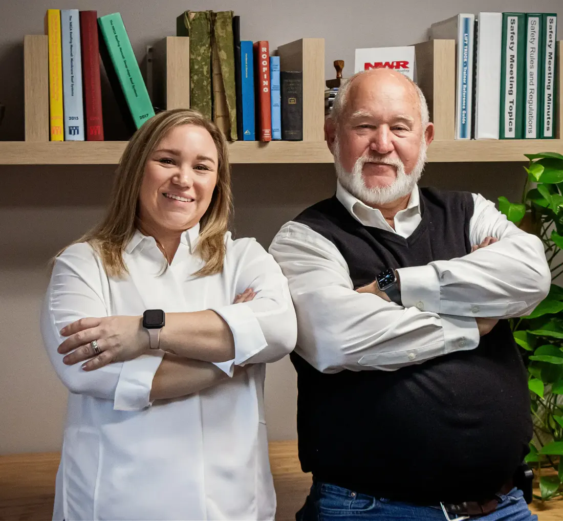 Katie Koetter Clymer and Richard Koetter, standing in front of a bookshelf