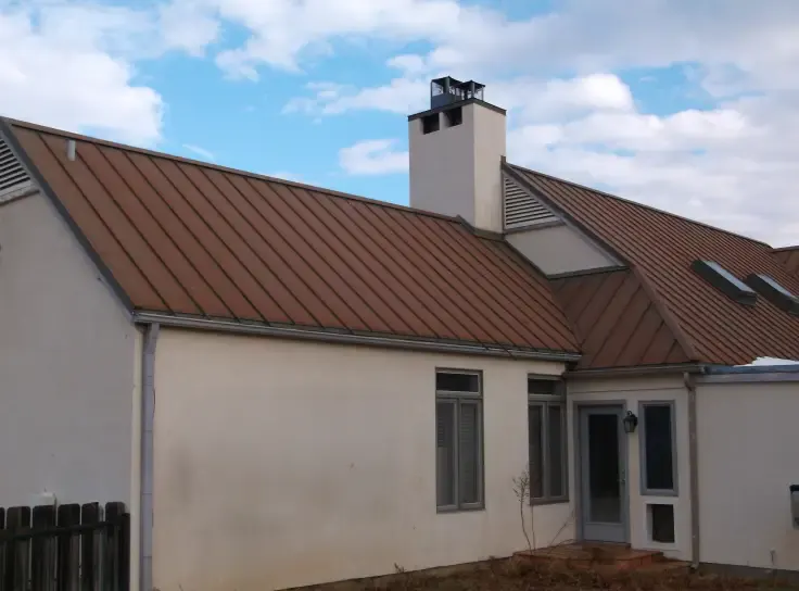 Brick ranch house under a big Texas sky